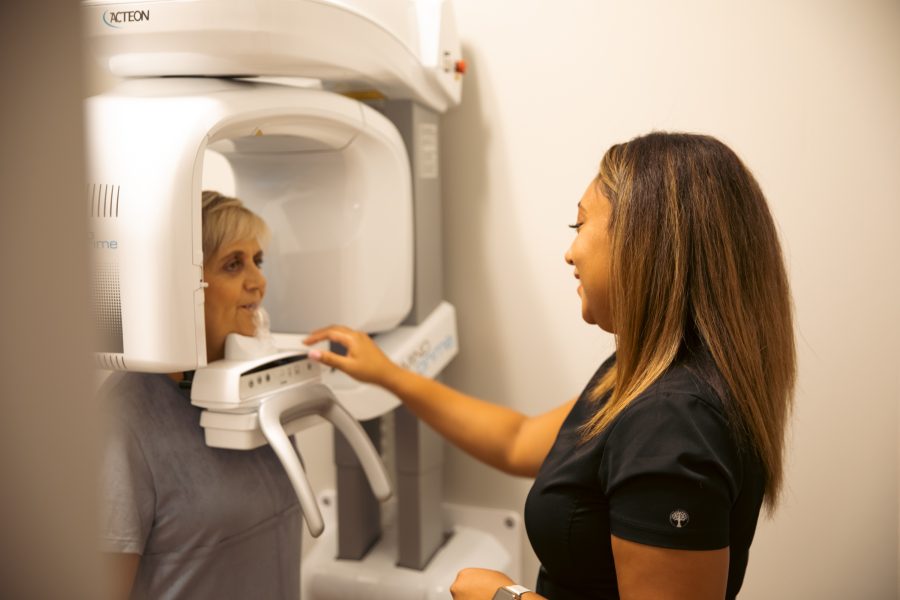 Dental assistant preparing a patient for an X-ray at Restore in 24.