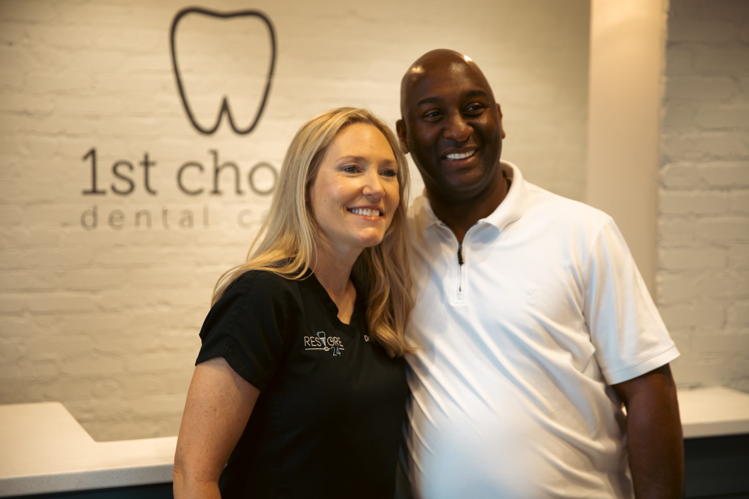 Full mouth dental implant patient smiling with the doctor