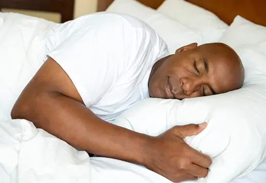 man asleep wearing implant dentures